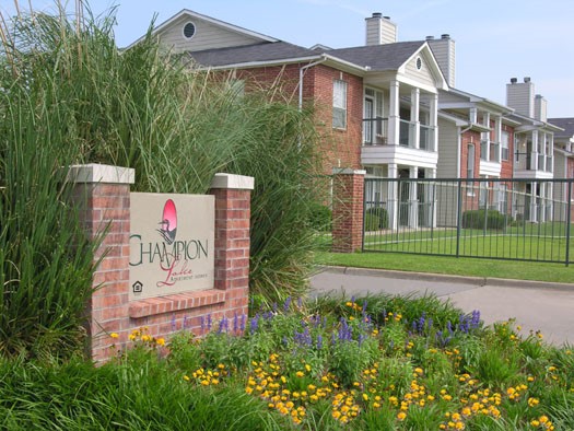 Champion Lake Apartments Big Brick Front Sign Leading Into the Complex